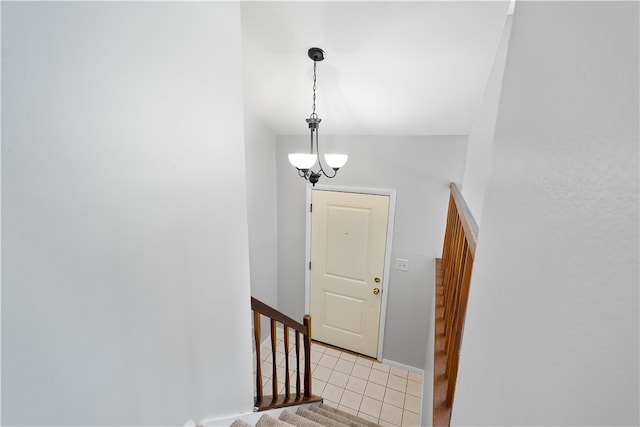 staircase featuring a chandelier and tile patterned floors