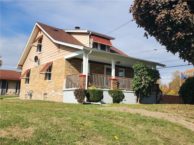 view of property exterior with a yard and a porch