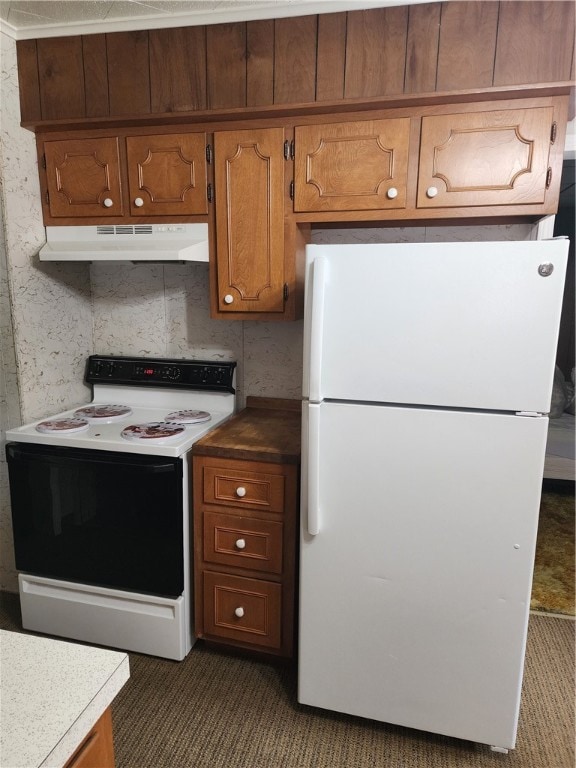 kitchen featuring white appliances and dark colored carpet