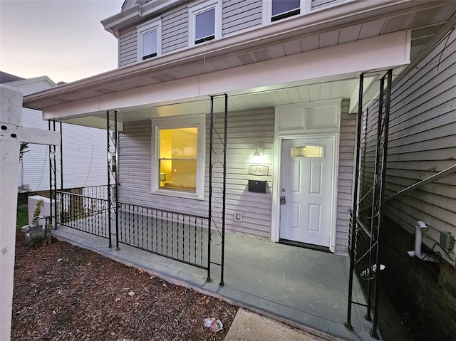 exterior entry at dusk with covered porch