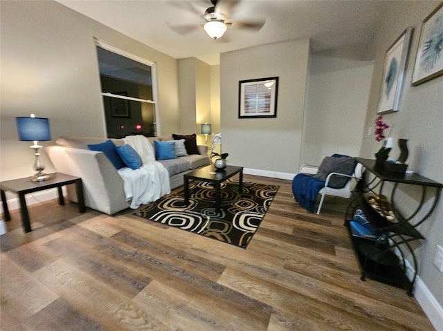 living room featuring wood-type flooring and ceiling fan