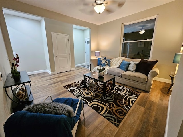 living room featuring light hardwood / wood-style flooring and ceiling fan