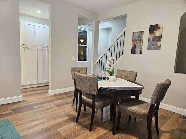 dining space with light hardwood / wood-style floors