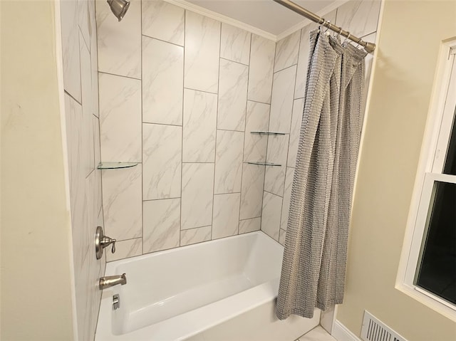 bathroom with ornamental molding and shower / tub combo