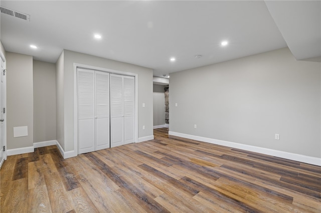 unfurnished bedroom with hardwood / wood-style flooring and a closet