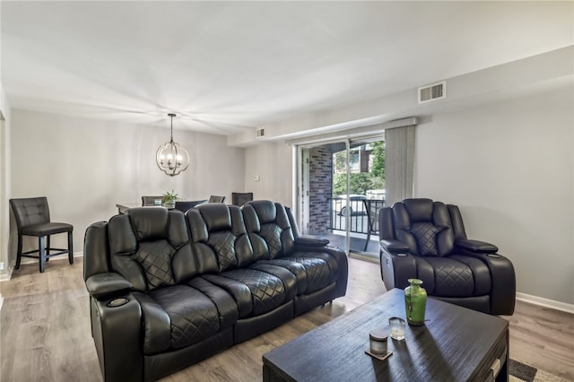 living room with a notable chandelier and wood-type flooring