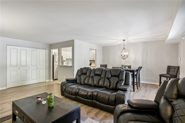 living room featuring a chandelier and light hardwood / wood-style floors