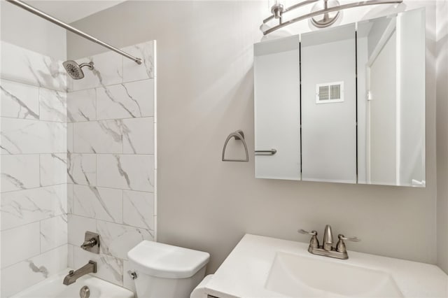 full bathroom with toilet, tiled shower / bath combo, and vanity