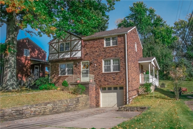 view of front facade with a porch, a front yard, and a garage