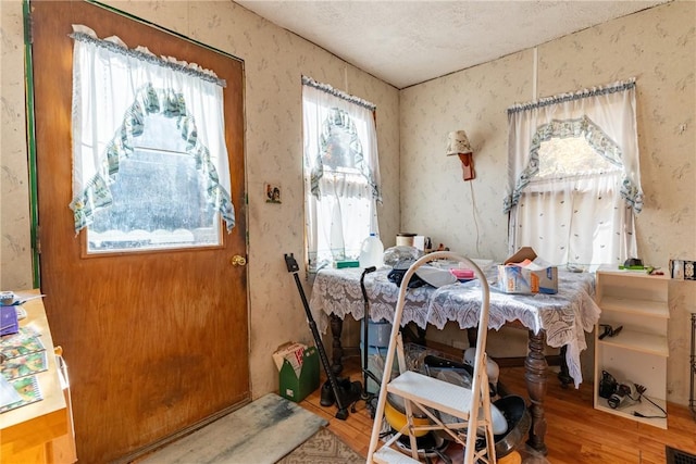 dining room with a textured ceiling and wood-type flooring