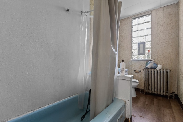 bathroom with toilet, shower / tub combo with curtain, hardwood / wood-style flooring, and radiator