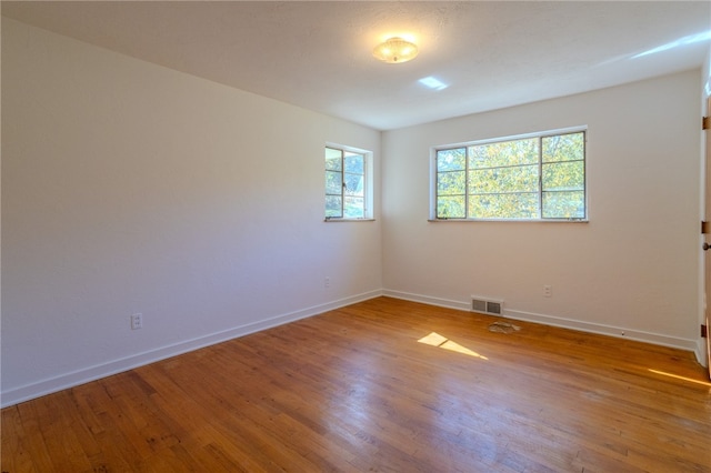 spare room with hardwood / wood-style flooring