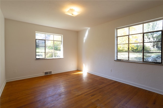 spare room with hardwood / wood-style flooring