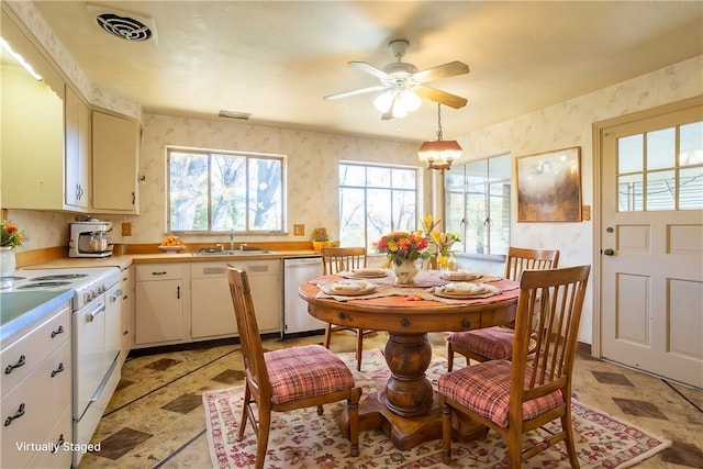 kitchen featuring sink, dishwasher, white cabinetry, decorative light fixtures, and white electric range oven