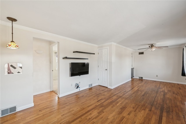 unfurnished living room featuring ornamental molding, hardwood / wood-style floors, and ceiling fan