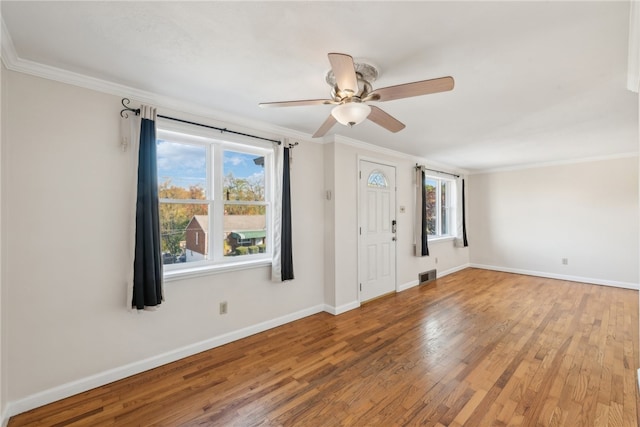 foyer entrance with crown molding, hardwood / wood-style flooring, and plenty of natural light