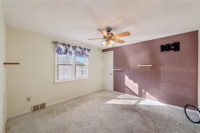 carpeted empty room with ceiling fan