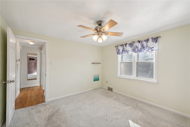 carpeted empty room featuring ceiling fan