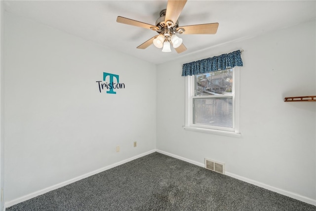 unfurnished room with ceiling fan and dark colored carpet