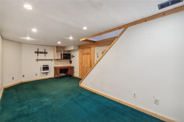 basement featuring heating unit and carpet floors