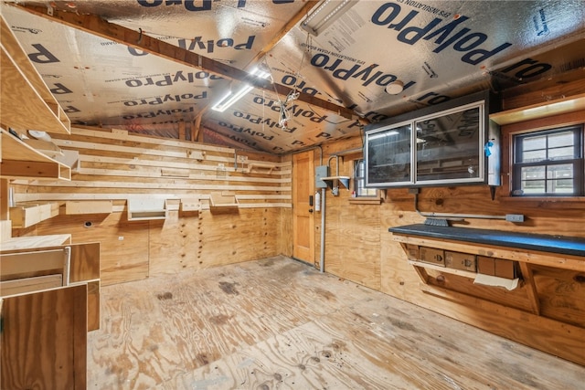 kitchen with lofted ceiling and wood walls