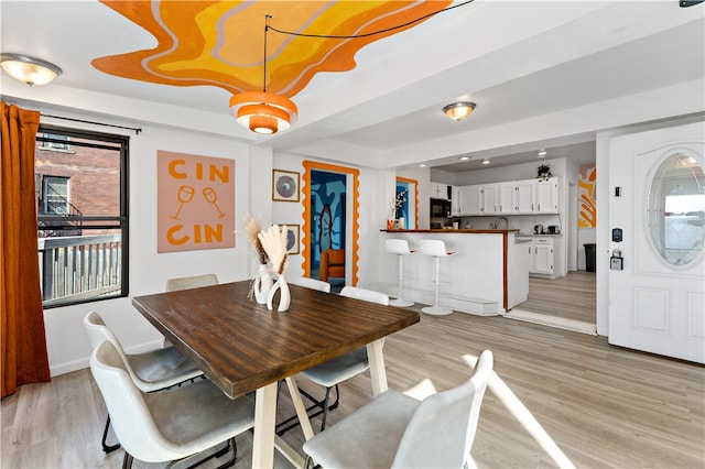 dining space with light wood-type flooring