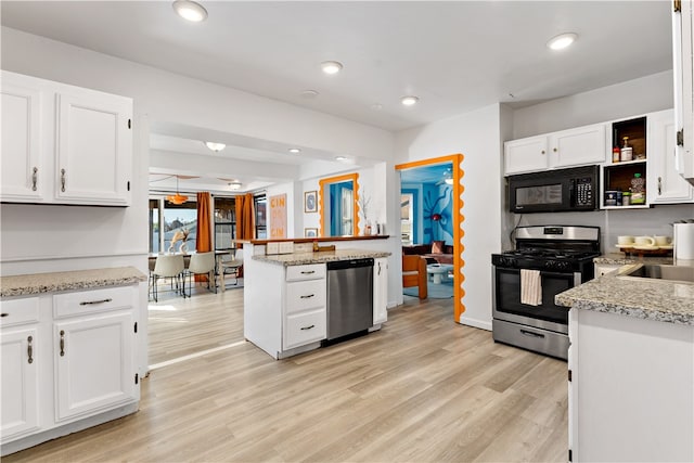 kitchen featuring appliances with stainless steel finishes, light hardwood / wood-style flooring, and white cabinetry