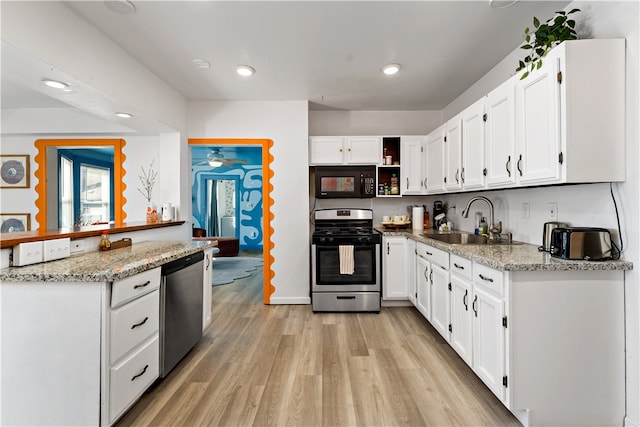 kitchen featuring light hardwood / wood-style floors, white cabinets, stainless steel appliances, and sink