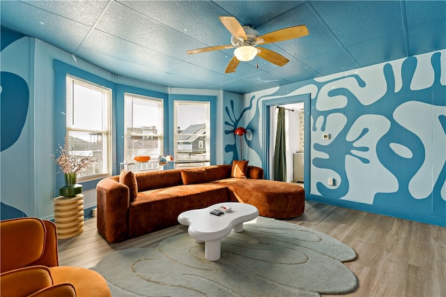 living room featuring light hardwood / wood-style floors and ceiling fan