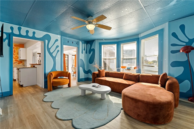 living room featuring light hardwood / wood-style flooring and ceiling fan