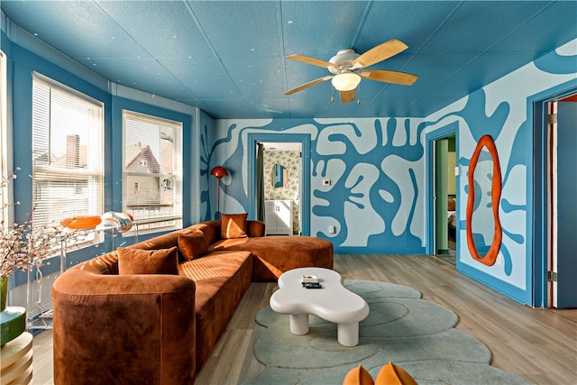 living room featuring light wood-type flooring and ceiling fan