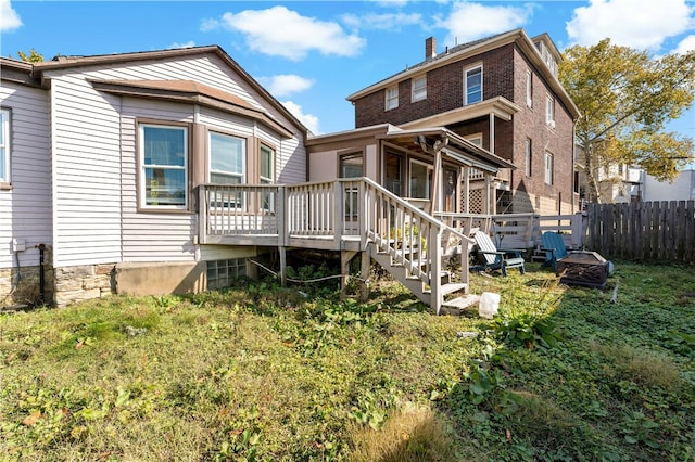 rear view of property featuring a deck