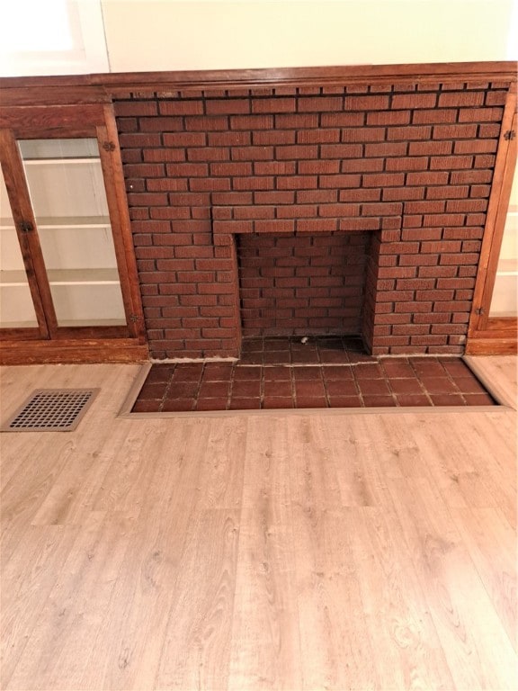 details featuring a fireplace and hardwood / wood-style flooring