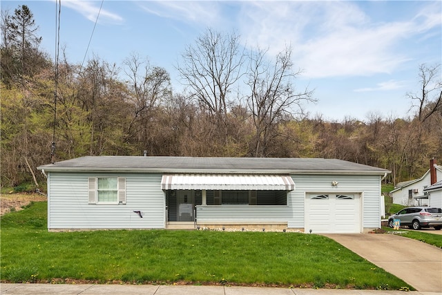 view of front of home with a front lawn and a garage