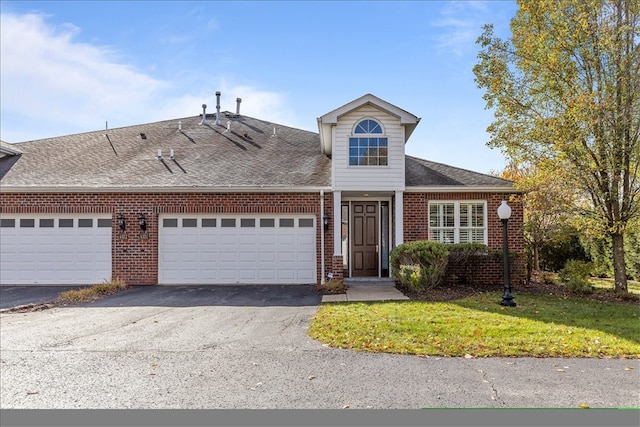 view of front of property featuring a front yard and a garage