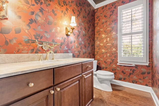 bathroom with vanity, hardwood / wood-style floors, crown molding, and toilet