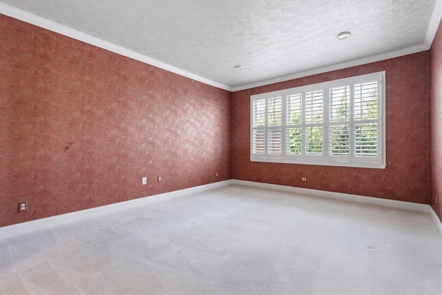 carpeted spare room featuring crown molding and a textured ceiling