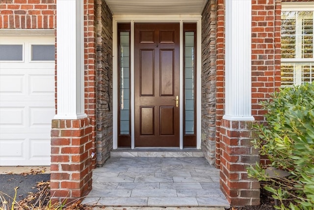 view of exterior entry with a garage