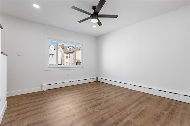 unfurnished room with hardwood / wood-style floors, a baseboard radiator, and ceiling fan