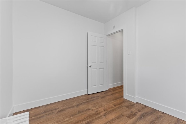 empty room with dark hardwood / wood-style floors