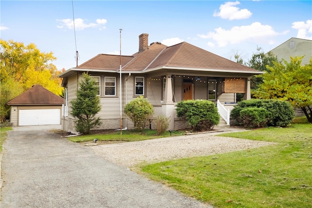 view of front facade with an outdoor structure, a porch, a front lawn, and a garage