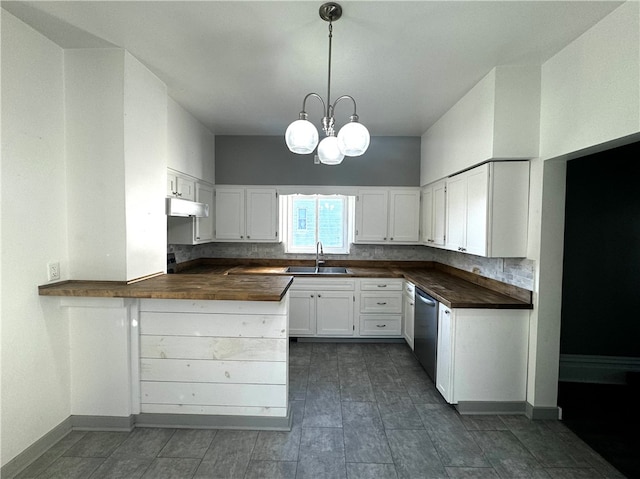 kitchen featuring white cabinetry, wood counters, sink, and pendant lighting