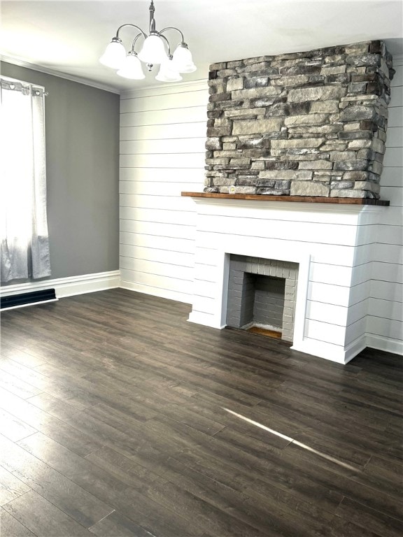 unfurnished living room with crown molding, a large fireplace, and dark hardwood / wood-style flooring