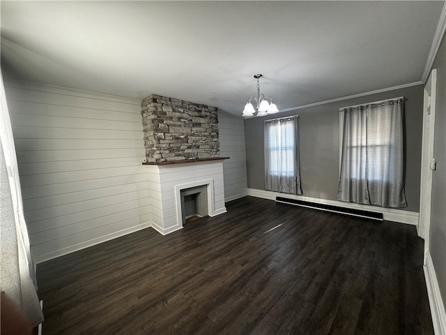 unfurnished living room featuring an inviting chandelier, dark hardwood / wood-style floors, a large fireplace, and crown molding