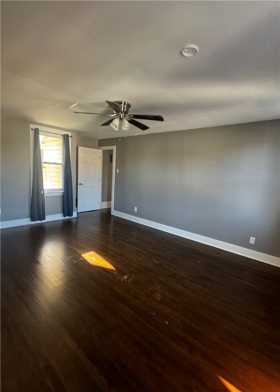 unfurnished room featuring dark hardwood / wood-style floors and ceiling fan