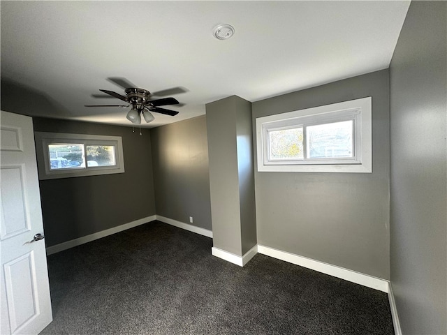 interior space featuring ceiling fan and dark colored carpet