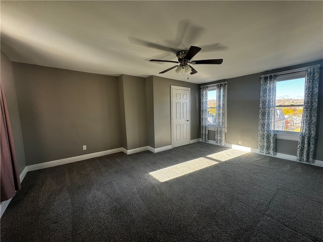 carpeted spare room with a healthy amount of sunlight and ceiling fan