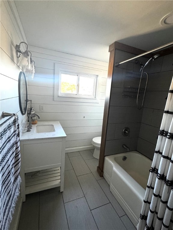 full bathroom with vanity, shower / tub combo with curtain, toilet, and wood walls