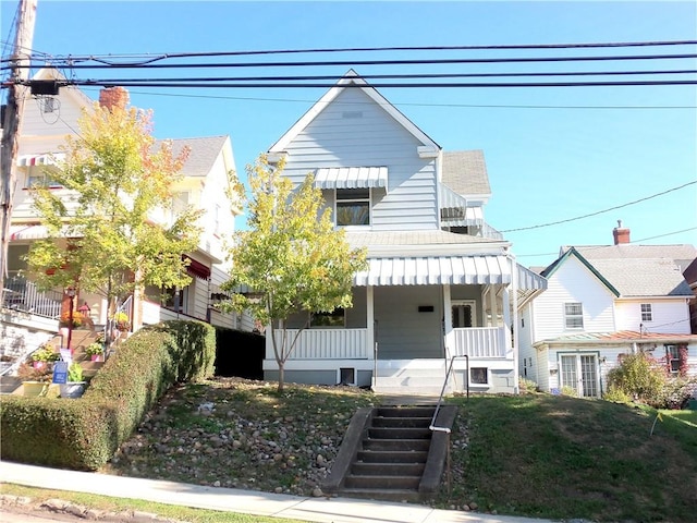 view of front facade featuring covered porch and a front yard