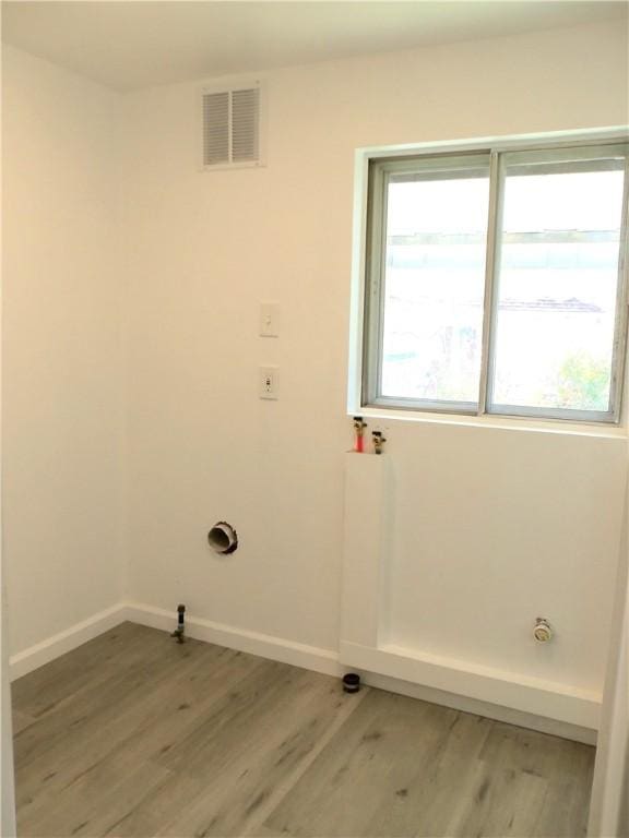 laundry area with light hardwood / wood-style flooring